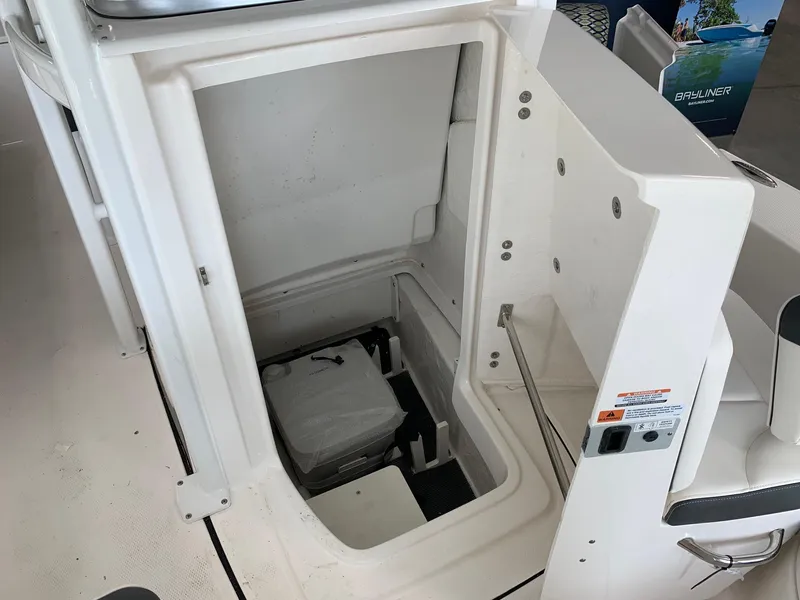 Slide: The Image of 2024 Robalo 226 Cayman boat storage compartment with portable toilet. - 10
