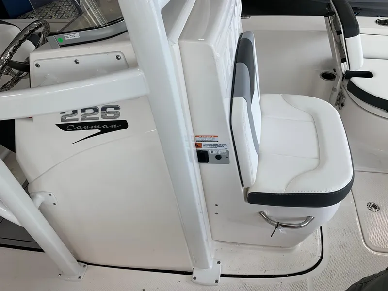 Slide: The Image of 2024 Robalo 226 Cayman boat interior with white seating and console. - 11