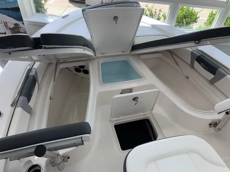 Slide: The Image of 2024 Robalo 226 Cayman boat interior with open storage compartments. - 12