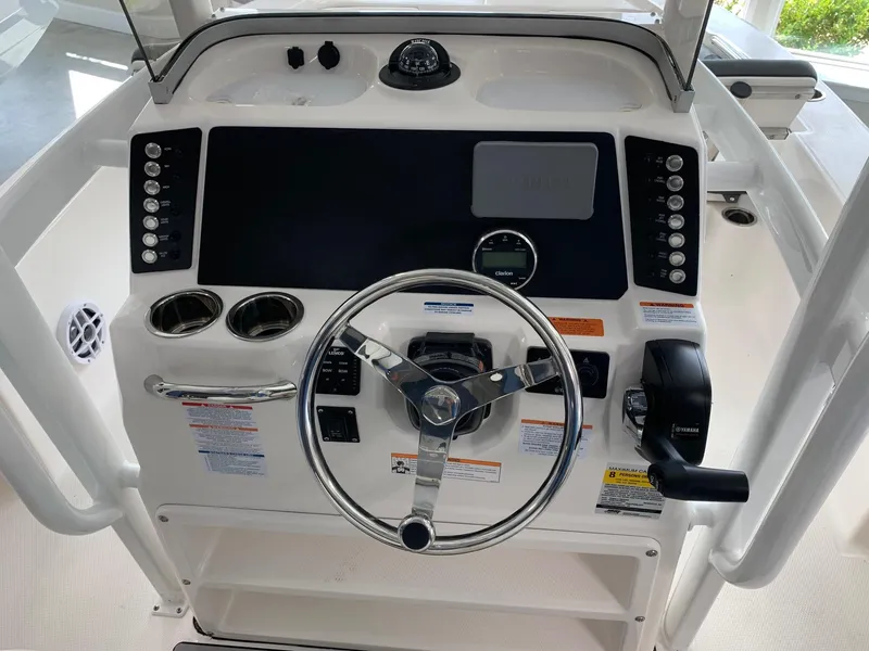 Slide: The Image of 2024 Robalo 226 Cayman boat console with steering wheel and control panel. - 4