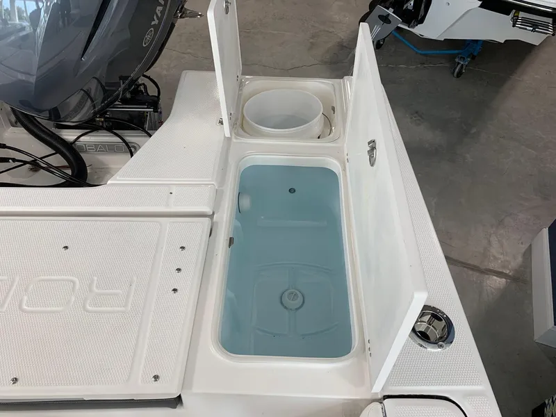 Slide: The Image of 2024 Robalo 226 Cayman boat with open storage compartments and livewell. - 5