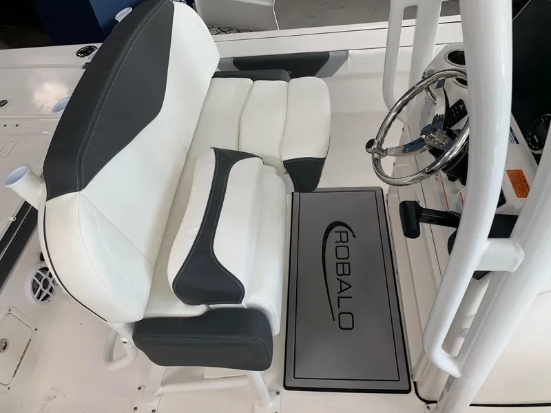 Slide: The Image of 2024 Robalo 226 Cayman boat interior with dual seating and steering console. - 8