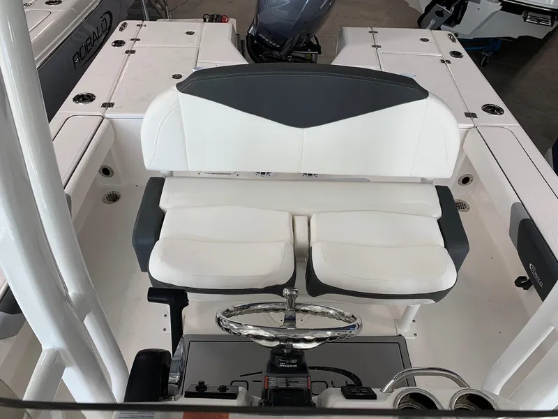 Slide: The Image of 2024 Robalo 226 Cayman boat interior with dual seating and steering console. - 9