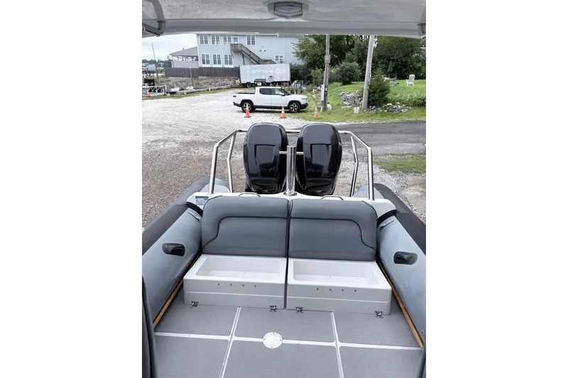 Slide: The Image of 2012 Protector Targa 30 boat interior with seating and dual outboard motors. - 11