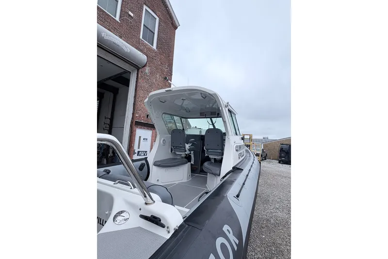 Slide: The Image of 2012 Protector Targa 30 boat docked near a brick building. - 4