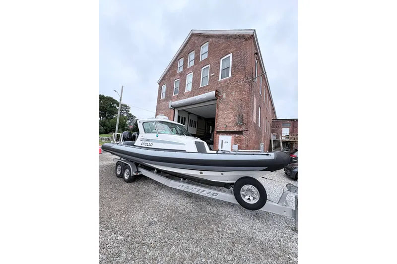 Slide: The Image of 2012 Protector Targa 30 boat on trailer outside brick building. - 12