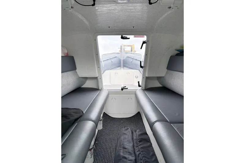 Slide: The Image of Interior view of 2012 Protector Targa 30 boat with gray seating and carpeted floor. - 10