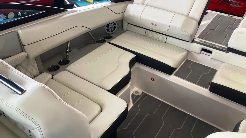 Slide: The Image of 2021 Regal LS2 Surf boat interior with white leather seating and cup holders. - 3
