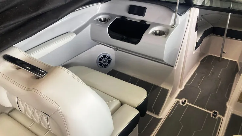 Slide: The Image of 2021 Regal LS2 Surf boat interior with white seating and modern dashboard. - 5