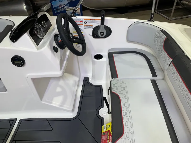 Slide: The Image of 2024 Bayliner Element M15 boat interior with steering wheel and seating. - 4