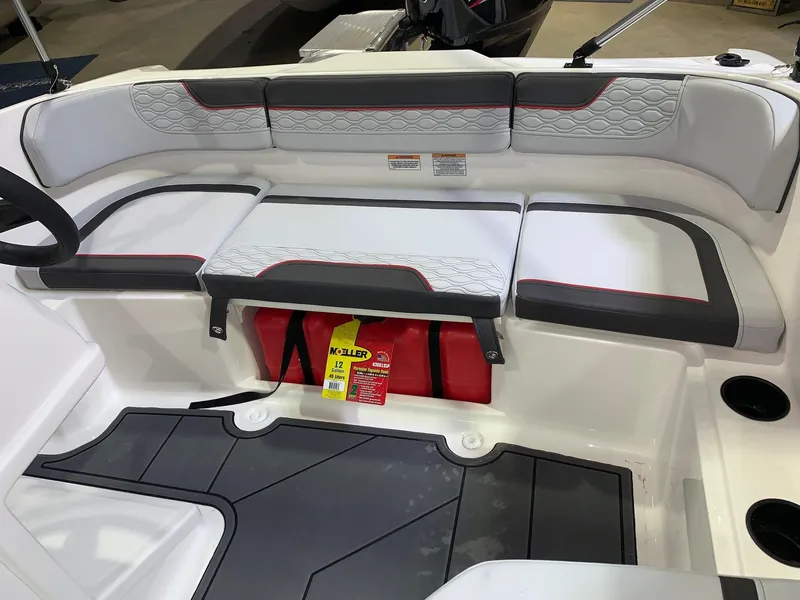 Slide: The Image of 2024 Bayliner Element M15 boat interior with cushioned seating and storage. - 5