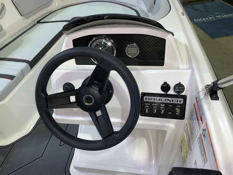 Slide: The Image of 2024 Bayliner Element M15 boat dashboard with steering wheel and control panel. - 8