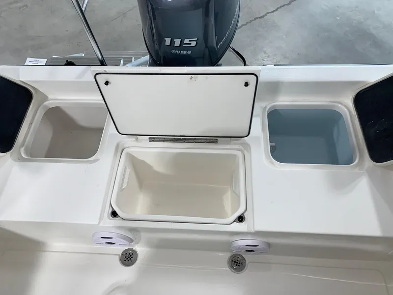 Slide: The Image of 2024 Key West 188 Bay Reef boat with Yamaha 115 engine, storage compartments open. - 4