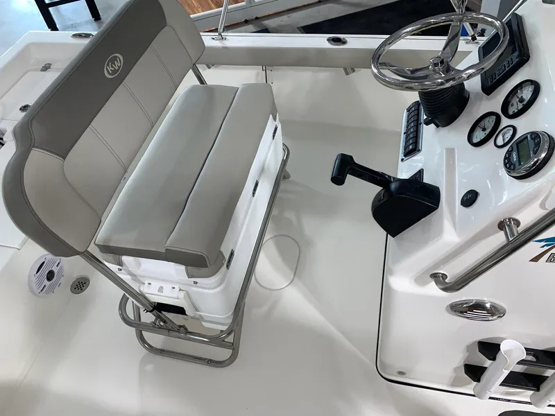 Slide: The Image of 2024 Key West 188 Bay Reef boat interior with steering console and cushioned seating. - 6