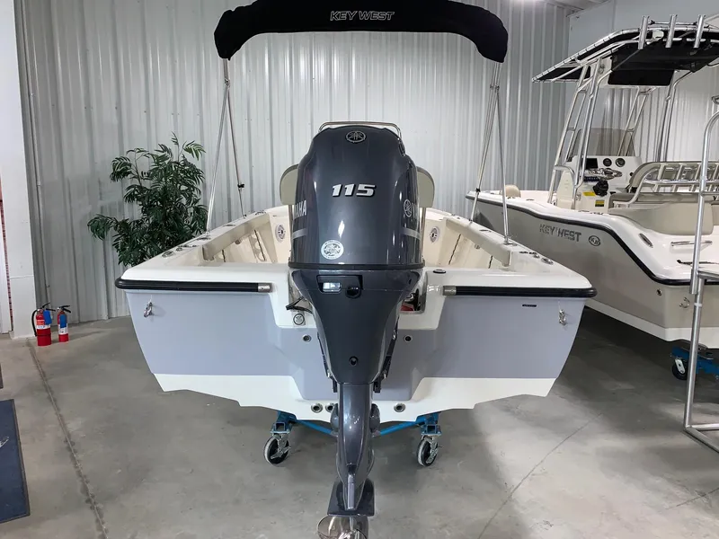 Slide: The Image of 2024 Key West 188 Bay Reef boat with 115 HP engine in showroom. - 2