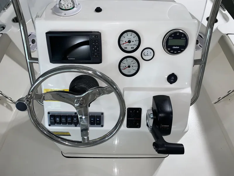 Slide: The Image of 2024 Key West 188 Bay Reef boat dashboard with steering wheel, gauges, and controls. - 7