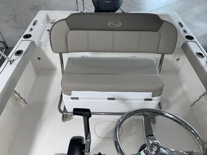 Slide: The Image of 2024 Key West 188 Bay Reef boat interior with steering wheel and cushioned seating. - 8