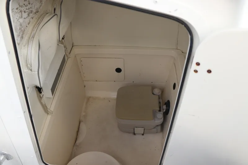 Slide: The Image of Interior of 2001 Boston Whaler Outrage 26 CC boat with compact marine toilet. - 11