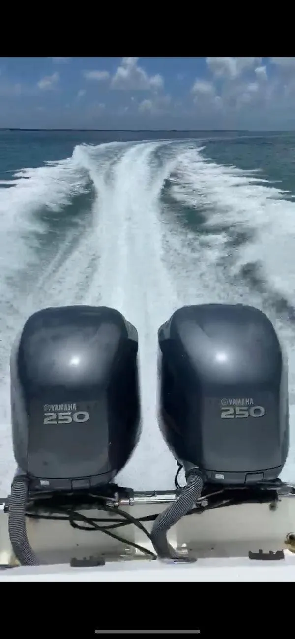 Slide: The Image of Boston Whaler Outrage 26 CC 2001 with twin Yamaha 250 engines cruising on open water. - 15