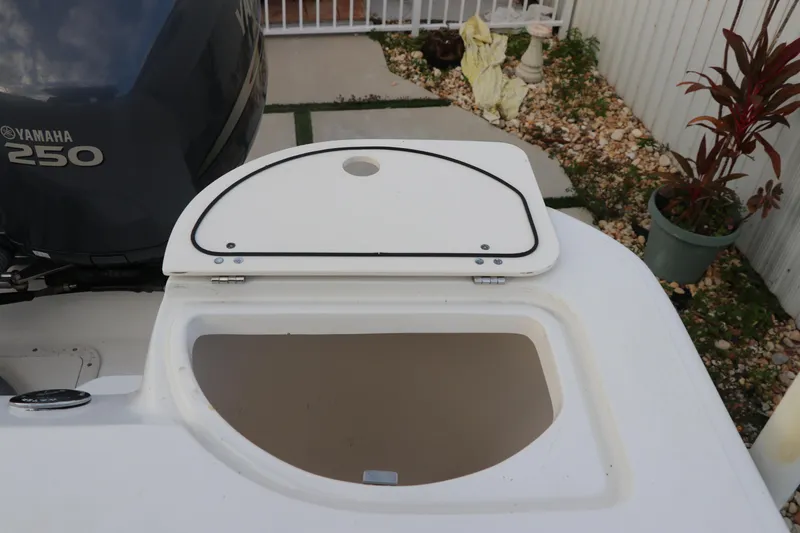 Slide: The Image of Open storage compartment on 2001 Boston Whaler Outrage 26 CC boat, near Yamaha 250 engine. - 17