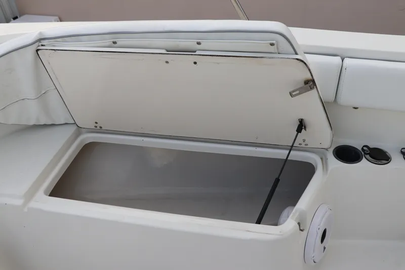 Slide: The Image of Open storage compartment on a 2001 Boston Whaler Outrage 26 CC boat. - 19