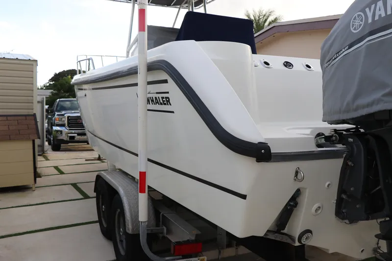 Slide: The Image of 2001 Boston Whaler Outrage 26 CC boat on trailer, rear view with Yamaha engine cover. - 2