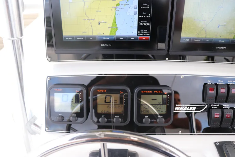 Slide: The Image of Control panel of a 2001 Boston Whaler Outrage 26 CC with navigation screens and gauges. - 22