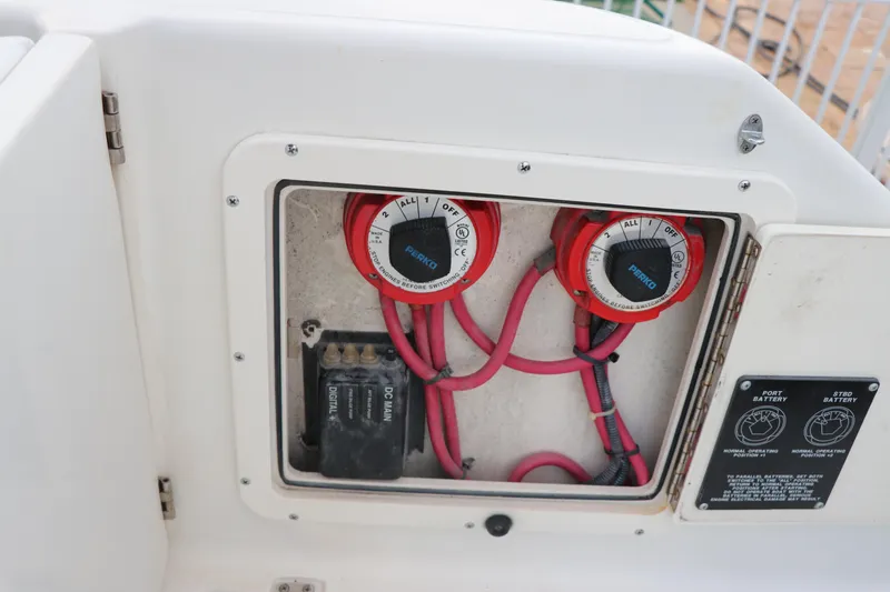 Slide: The Image of Electrical panel of a 2001 Boston Whaler Outrage 26 CC boat, featuring wiring and switches. - 23