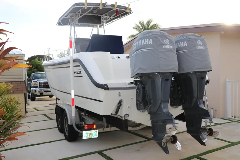 Slide: The Image of 2001 Boston Whaler Outrage 26 CC boat with dual Yamaha engines on a trailer. - 26