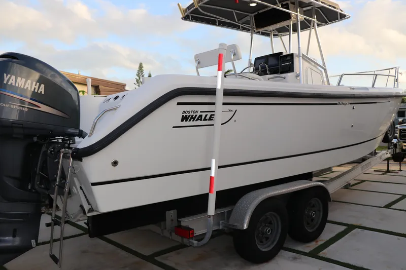 Slide: The Image of 2001 Boston Whaler Outrage 26 CC boat on trailer with Yamaha outboard motor. - 3