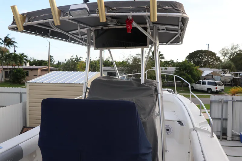 Slide: The Image of 2001 Boston Whaler Outrage 26 CC boat with covered console and T-top in residential area. - 4