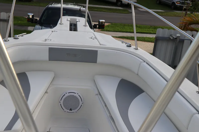 Slide: The Image of 2001 Boston Whaler Outrage 26 CC boat interior with white seating and speaker. - 5