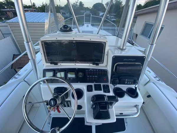 Slide: The Image of 2001 Boston Whaler Outrage 26 CC boat console with steering wheel and controls. - 6
