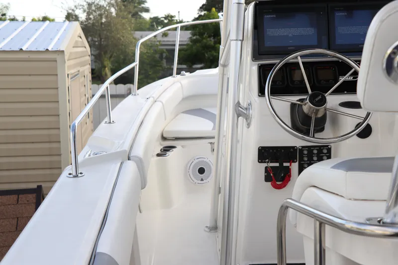 Slide: The Image of 2001 Boston Whaler Outrage 26 CC boat cockpit with steering wheel and control panel. - 8