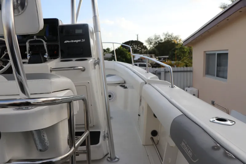 Slide: The Image of 2001 Boston Whaler Outrage 26 CC boat interior with seating and control panel. - 9