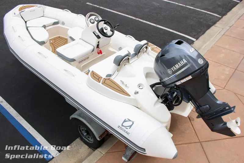 The Image of 2024 Zodiac Yachtline 440 inflatable boat with Yamaha outboard motor on trailer. - 1