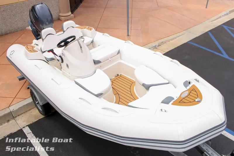 Slide: The Image of 2024 Zodiac Yachtline 440 inflatable boat on trailer, showcased by Inflatable Boat Specialists. - 2
