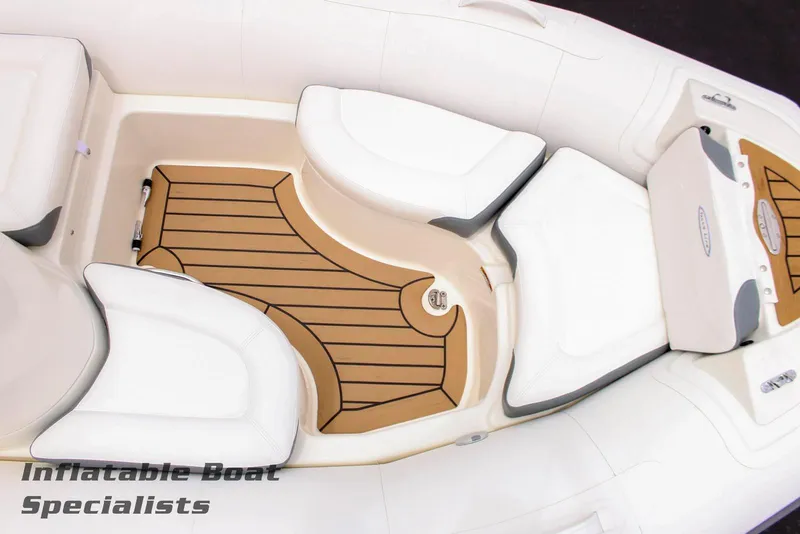 Slide: The Image of 2024 Zodiac Yachtline 440 inflatable boat interior with cushioned seating and teak flooring. - 4
