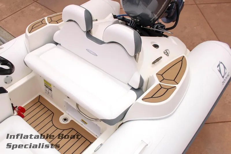 Slide: The Image of 2024 Zodiac Yachtline 440 inflatable boat interior with cushioned seating and teak flooring. - 5