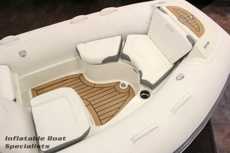 Slide: The Image of 2024 Zodiac Yachtline 490 inflatable boat interior with cushioned seating and teak flooring. - 4