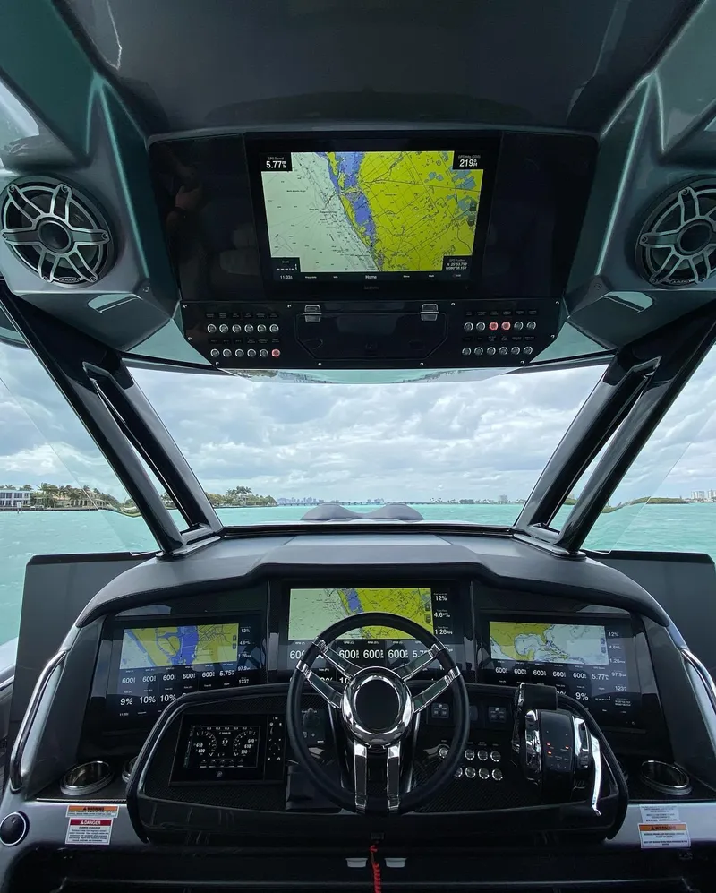 Slide: The Image of 2025 MTI V50 boat dashboard with advanced navigation screens and controls. - 1
