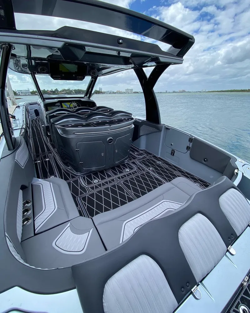 Slide: The Image of 2025 MTI V50 luxury speedboat interior with modern seating and sleek design on a sunny day. - 3