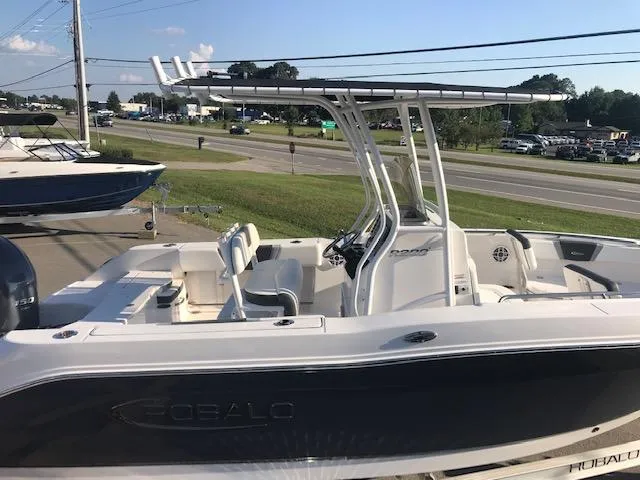 Slide: The Image of 2024 Robalo R200 Center Console boat on display near a road. - 2