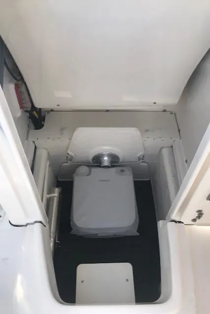 Slide: The Image of 2024 Robalo R200 Center Console boat interior with portable toilet. - 9