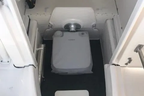 Slide: The Image of 2024 Robalo R200 Center Console boat interior with portable toilet. - 11