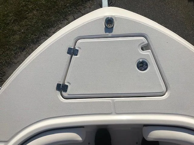 Slide: The Image of 2024 Robalo R200 Center Console bow storage compartment with hatch and latches. - 4