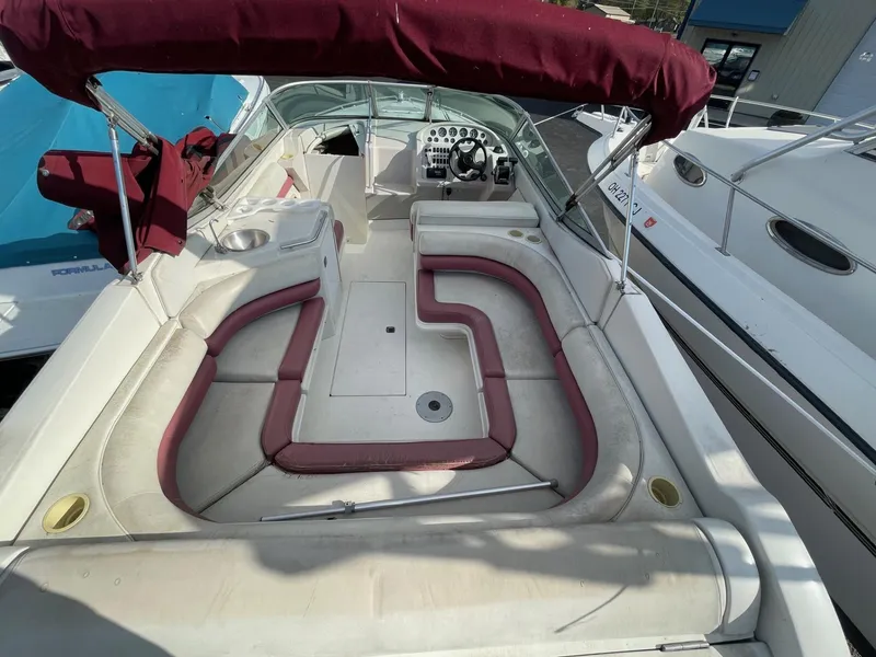 Slide: The Image of 1992 Regal Ventura boat with maroon seating and canopy, spacious deck layout. - 4