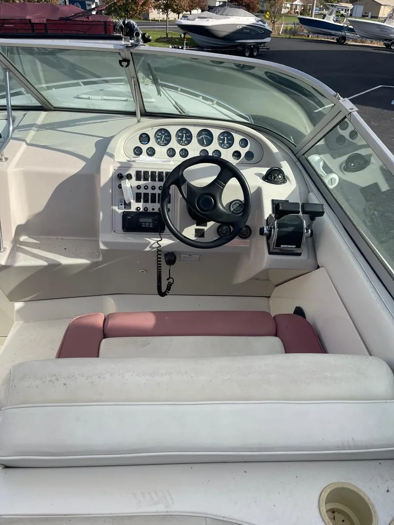Slide: The Image of 1992 Regal Ventura boat cockpit with steering wheel and control panel. - 5