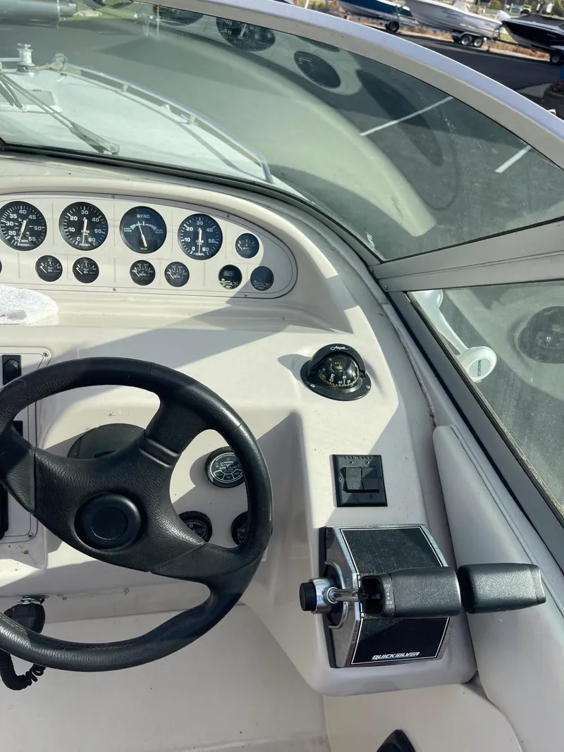 Slide: The Image of 1992 Regal Ventura boat dashboard with steering wheel and control panel. - 7