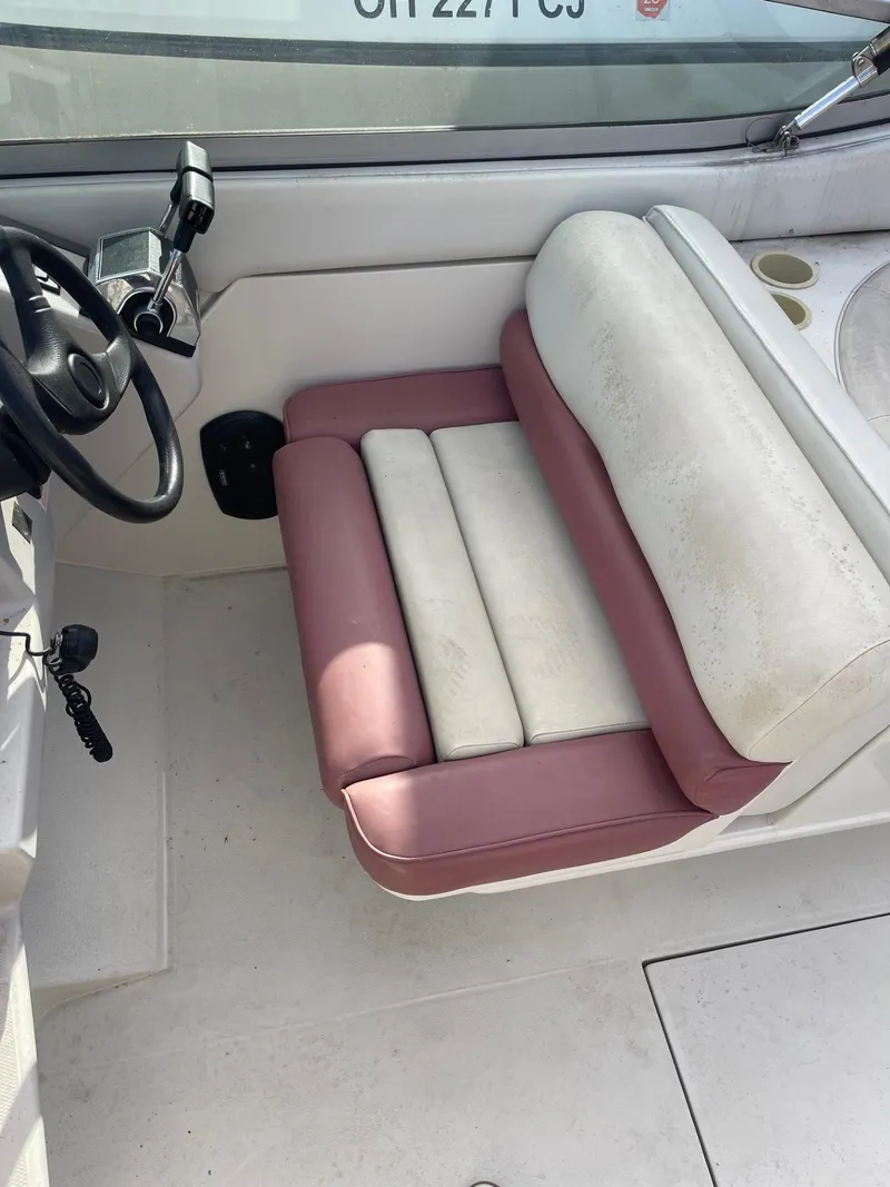 Slide: The Image of 1992 Regal Ventura boat interior with white and pink seating, steering wheel, and cup holders. - 8